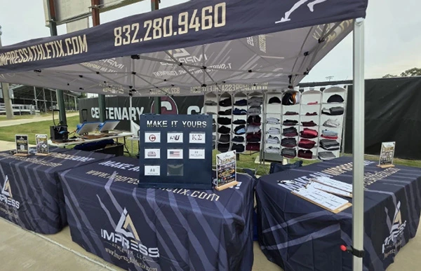 Close up of Impress Athletix booth at Centenary College Military Heroes Game.