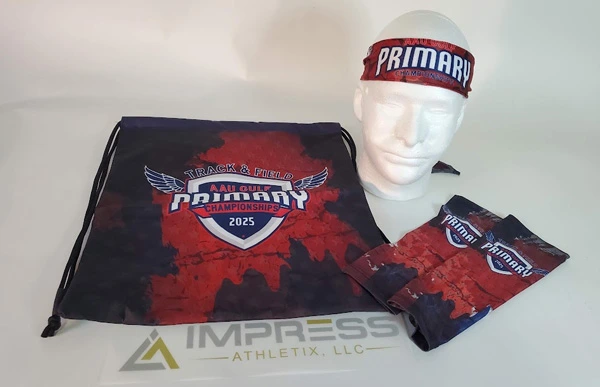 Custom 2025 AAU Gulf Track & Field Primary Championship merchandise, including a drawstring bag, headband, and folded shirt.