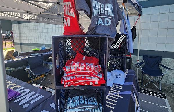 Track Mom and Track Dad shirts displayed at the Impress Athletix booth at the PTX Spring Classic.