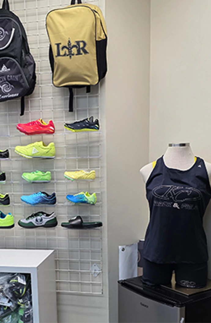 Impress Athletix sporting goods display with track shoes, backpacks, and custom team apparel