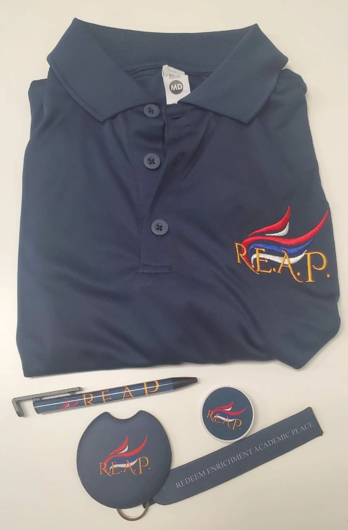 REAP branded polo, pen, keychain, and promotional items customized by Impress Athletix