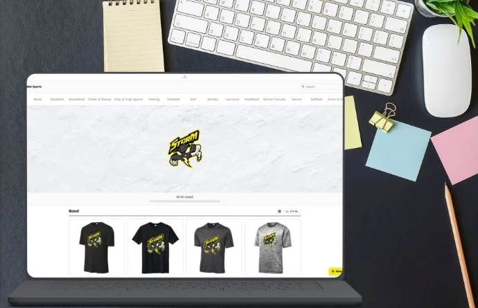 Online Athletix Shop displaying custom team apparel on a laptop