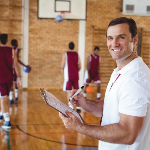 Coach managing team information from a tablet in a gym